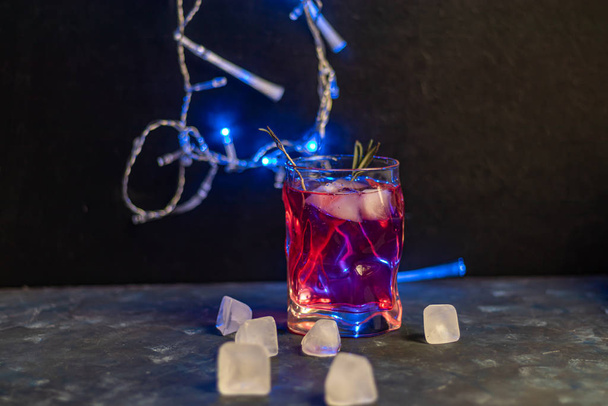 Celebratory drink, rose wine on a dark background. New Year's props, artificial snow. Copy space.  - Foto, Imagem