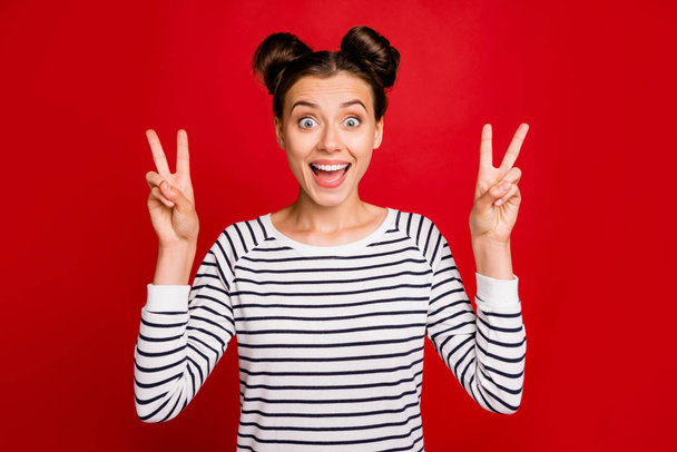 Portrait of cheerful teen girl have free time make v-sign wear casual style white clothing isolated over red color background - Valokuva, kuva