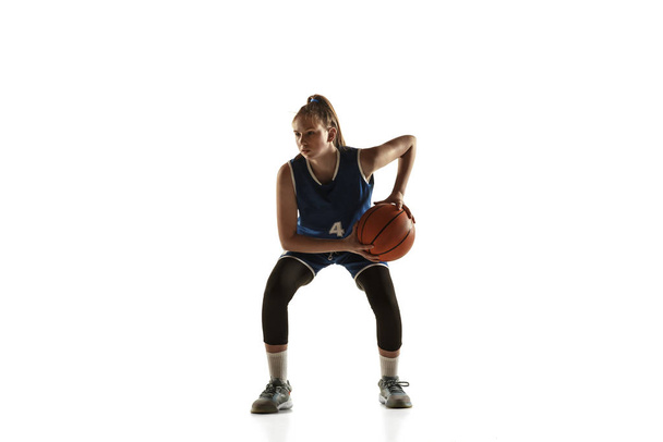 Young caucasian female basketball player against white studio background - Foto, Imagen