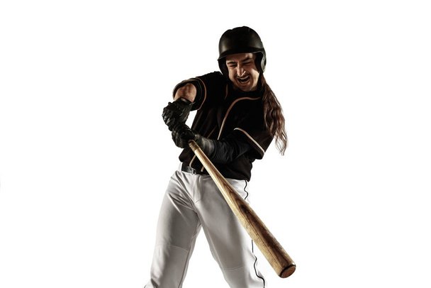 Baseball player, pitcher in a black uniform practicing on a white background. - Photo, image