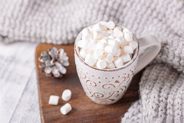 Mug with coffee and marshmallow, sweater, cinnamon. Cozy christmas composition. Hygge concept Soft focus - Fotoğraf, Görsel