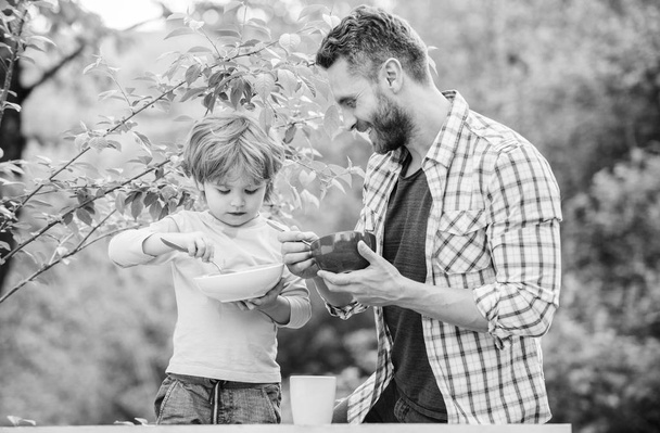 Nutrition kids and adults. Organic nutrition. Healthy nutrition concept. Nutrition habits. Family enjoy homemade meal. Personal example. Father teach son eat natural food. Little boy and dad eat - Photo, Image