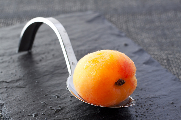 Apricot on spoon - Zdjęcie, obraz