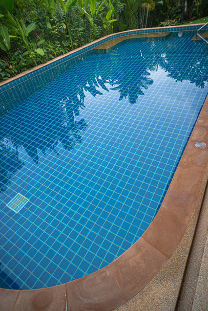 modrá voda v bazénu vedle hous - Fotografie, Obrázek