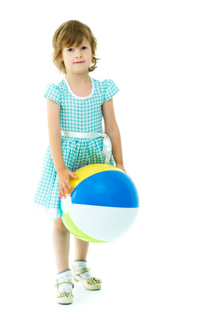 Little girl is playing with a ball - Фото, изображение