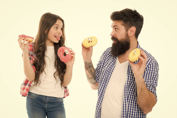 Happy family. Let me help you. little child love her dad. father and daughter eating donut. having fun together. fathers day. childrens day. family bonds. happy little girl with father. donut cooking - Foto, Bild