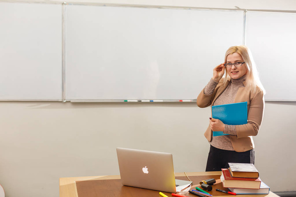 beautiful teacher in classroom with laptop - Photo, Image