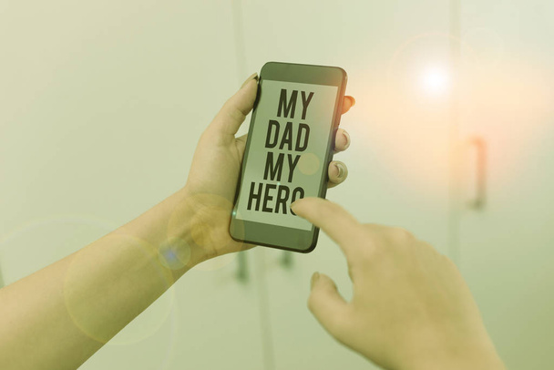 Word writing text My Dad My Hero. Business concept for Admiration for your father love feelings emotions compliment woman using smartphone office supplies technological devices inside home. - Photo, Image
