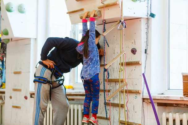 little girl climber in leisure park with climbing wall  - Foto, Imagen