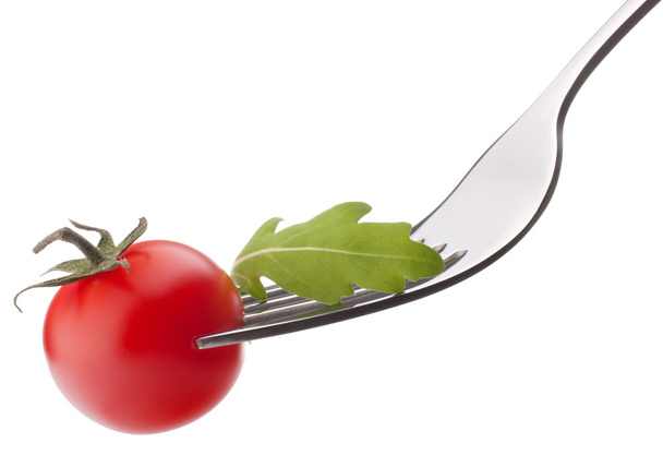 Fresh rucola salad and cherry tomato on fork isolated on white - Foto, Imagen