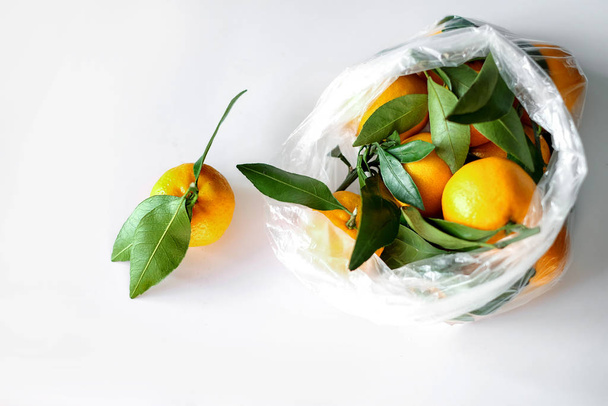 Fresh mandarins in plastic supermarket pakage at white background, copyspace - Фото, зображення
