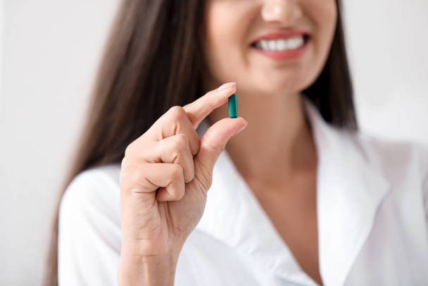 Doctor with pill in clinic, closeup - Photo, Image