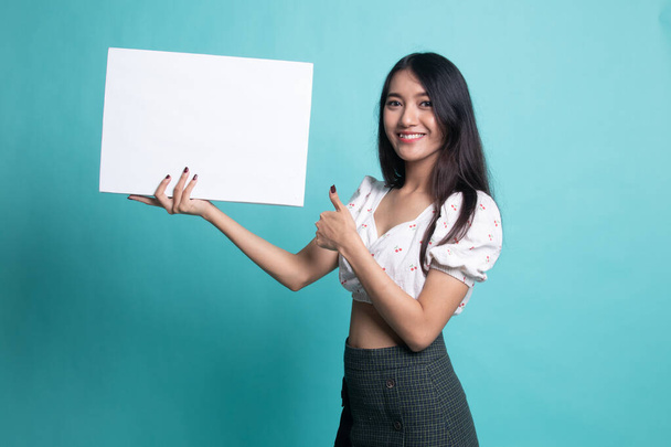 Young Asian woman show thumbs up with  white blank sign - Foto, afbeelding
