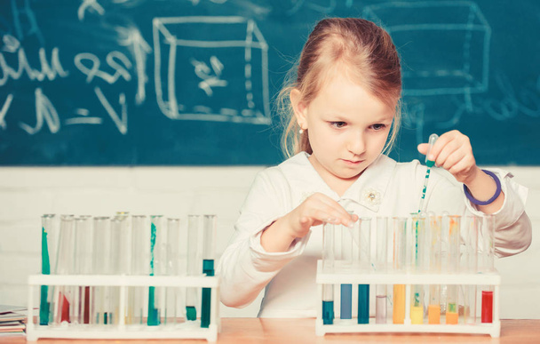 School education. Interesting approach to learn. Kid like to experiment. Explore and investigate. School lesson. Girl cute pupil play with test tubes and colorful liquids. School chemical experiment - Φωτογραφία, εικόνα