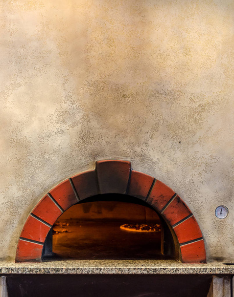 Pizza baking in stone oven - Foto, imagen
