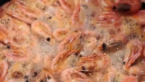 Cooking shrimp, adding black pepper, seasoning. Sea food close up - Footage, Video
