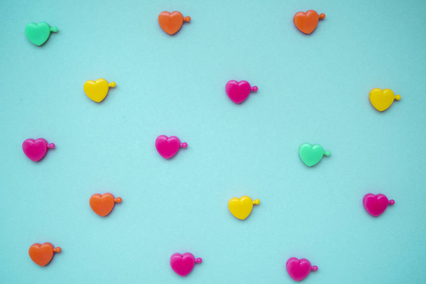 multicolored plastic hearts on a blue background - Photo, Image