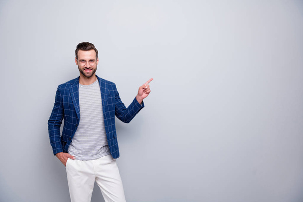 Portrait of his he nice attractive imposing cheerful cheery bearded gentleman in checked blazer showing copy empty blank place space advert isolated over light grey pastel color background - Фото, зображення
