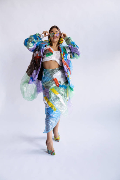 Woman addicted of sales and clothes, wearing plastic, recycling concept - Foto, immagini