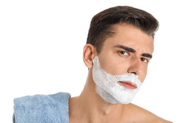 Handsome young man with shaving foam on his face against white background - Fotoğraf, Görsel