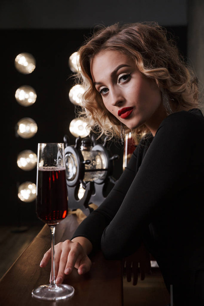 Image of glamour blonde woman wearing elegant dress drinking red - Fotó, kép