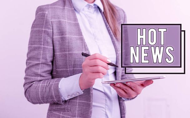 Word writing text Hot News. Business concept for subject that experiences surge in popularity on social media Business woman pointing in empty space with pen. - 写真・画像