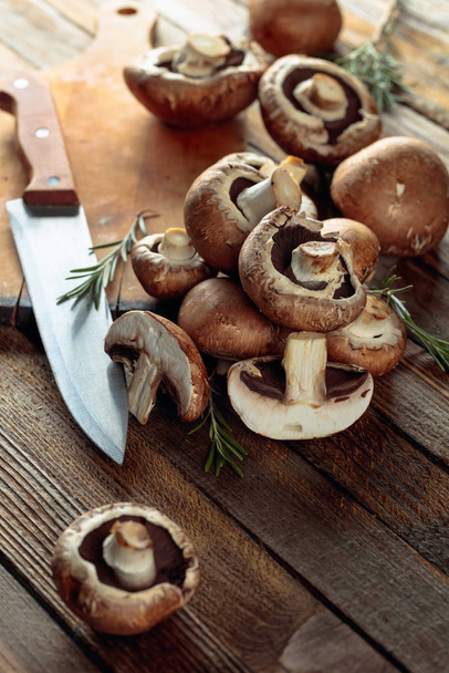 Fresh mushrooms champignon on a old wooden table.  - Foto, immagini
