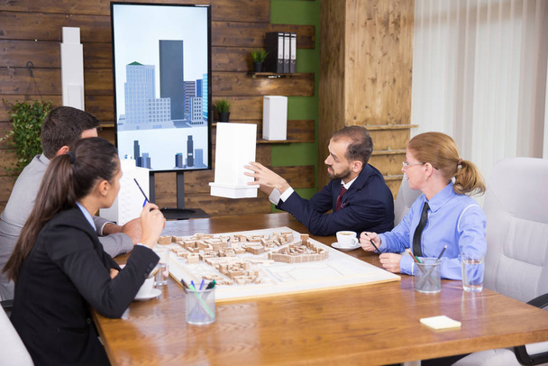 Μηχανικοί κατασκευών με επαγγελματική στολή σε συνάντηση με ομάδα αρχιτεκτόνων - Φωτογραφία, εικόνα
