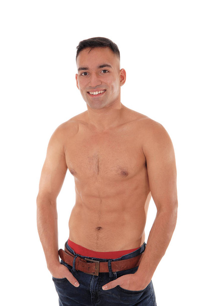 Shirtless man standing in jeans and smiling - Foto, immagini