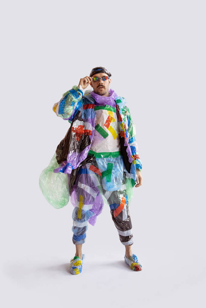 Man addicted of sales and clothes, wearing plastic, recycling concept - Fotografie, Obrázek