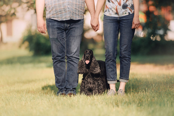 young family and their dog posing outdoors in summer - Foto, immagini