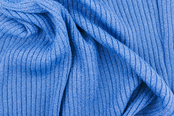 Blue knitted shiny striped and crumpled fabric, abstract background. - Foto, imagen
