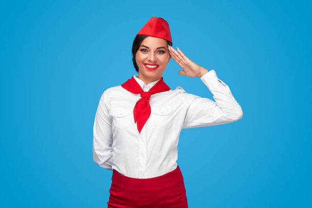 Friendly air hostess saluting for camera - Foto, Bild