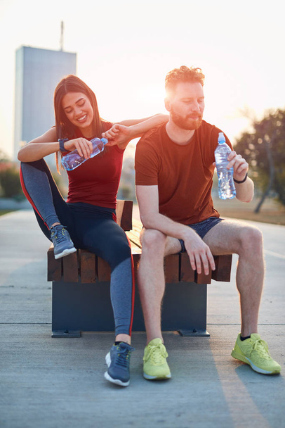 Modern couple making pause in an urban park during jogging / exe - Photo, Image