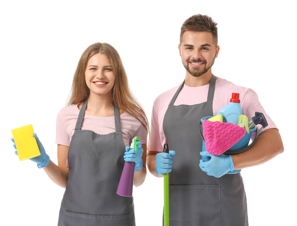 Team of janitors with cleaning supplies on white background - Photo, Image