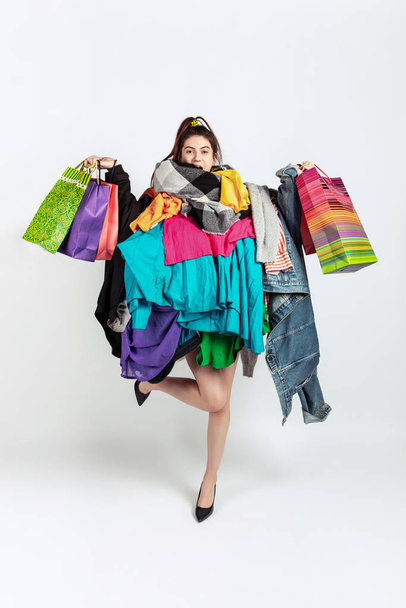 Woman addicted of sales and clothes, overproduction and crazy demand - Photo, image