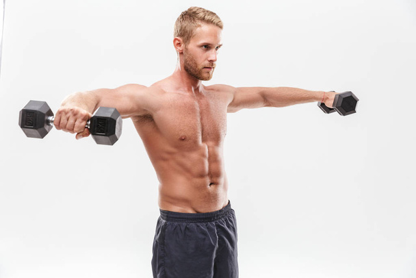 Confident attractive young muscular sportsman standing - Valokuva, kuva