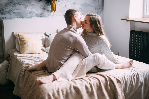couple kissing in their bedroom near the window - Zdjęcie, obraz