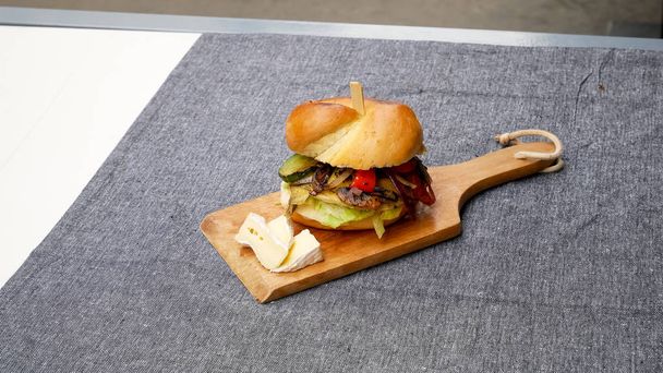Meaty hamburger in a restaurant - Фото, зображення