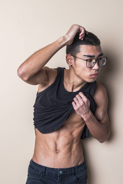 Young sexy man in glasses posing and show your body - Foto, imagen