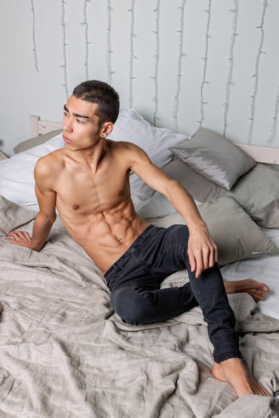 Young handsome man rest in bed. Sexy naked guy is resting - Фото, зображення