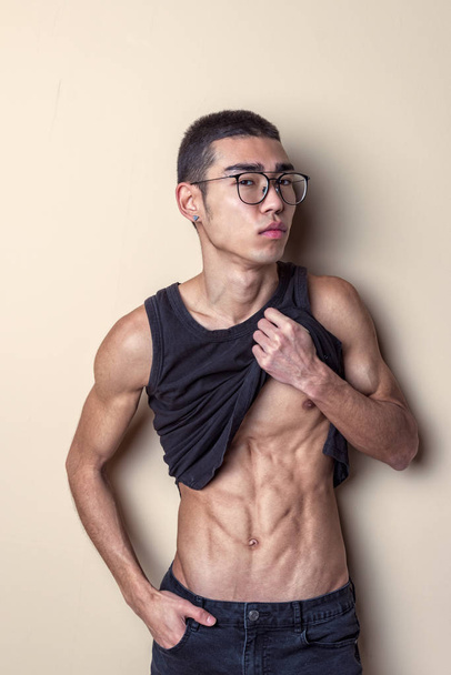 Young sexy man in glasses posing and show your body - Photo, image