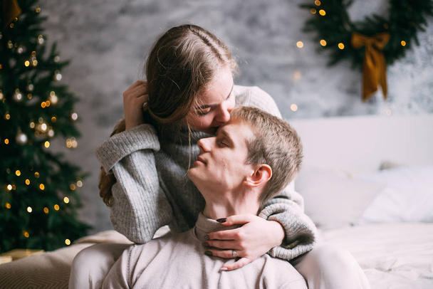 young couple kissing at home on Christmas time - Fotografie, Obrázek