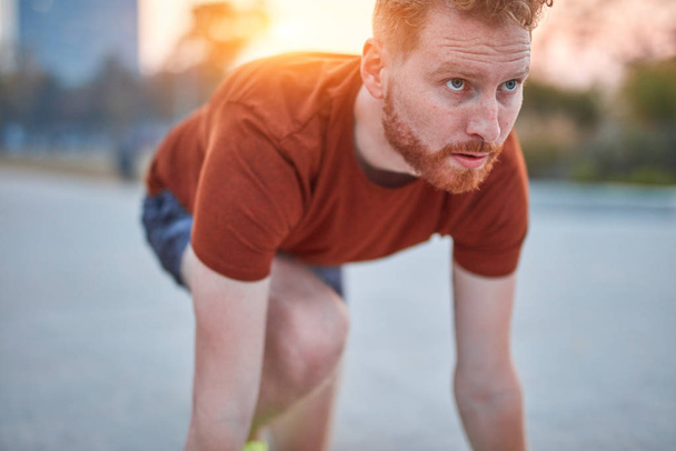 Young modern man jogging / exercising in an urban park. - Zdjęcie, obraz