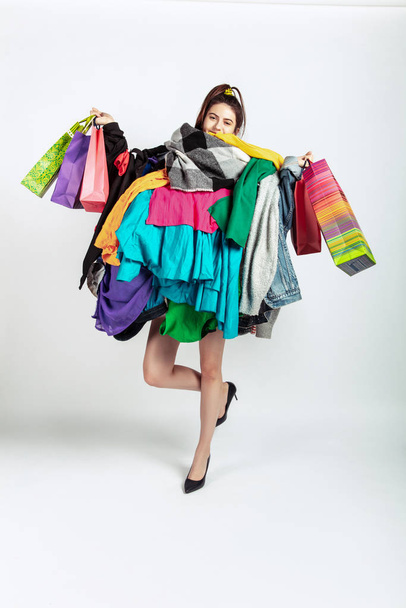 Woman addicted of sales and clothes, overproduction and crazy demand - Фото, изображение