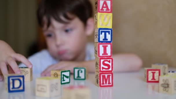 Детские руки, делающие аутизм слово из блоков, расстройства спектра, реабилитационный центр
 - Кадры, видео