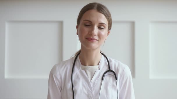 Young woman doctor talk by video chat consult patient online - Felvétel, videó