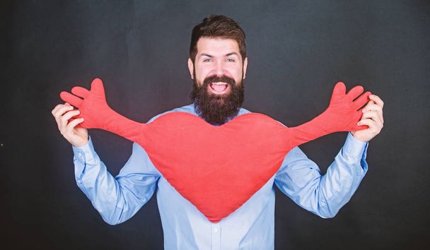 Free hugs. Man bearded hipster hug heart. Celebrate valentines day. Guy with beard and mustache in love romantic mood. Feeling love. Dating and relations concept. Happy in love. Physical touch - Valokuva, kuva