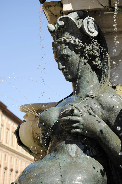 Detail with a lactating nereid. The Fountain of Neptune is a monumental civic fountain located in the eponymous square, Piazza del Nettuno. Bologna, Italy - Photo, Image