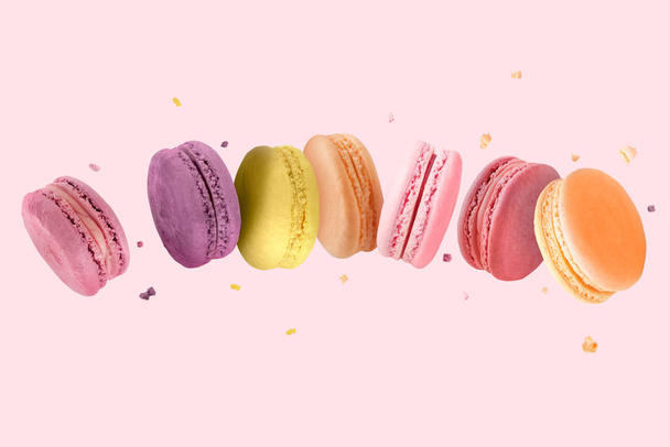 Falling tasty macarons on color background - Photo, Image